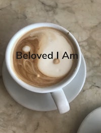 a cup of coffee with the words beloved i am
